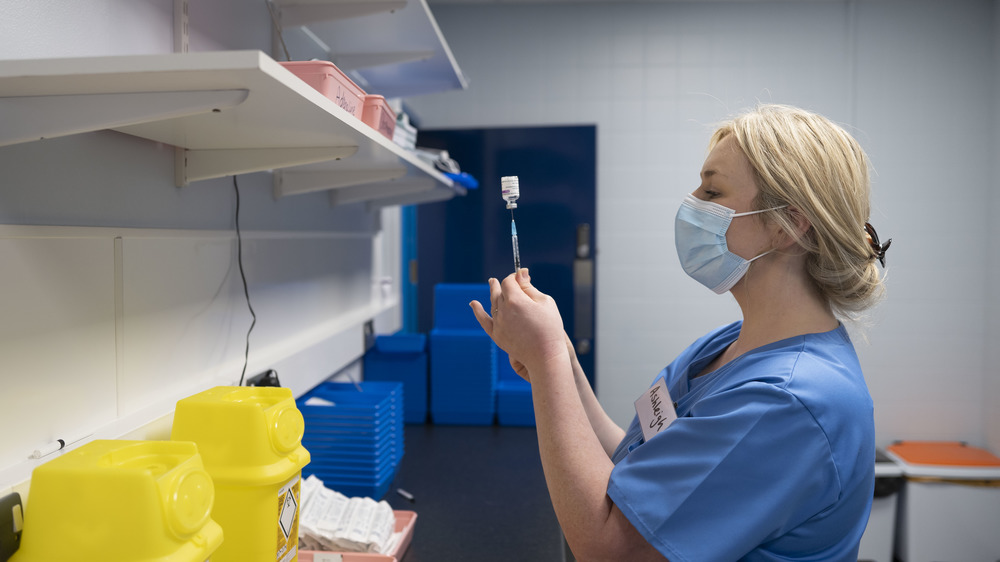 Nurse preparing needle at COVID-19 vaccination drive