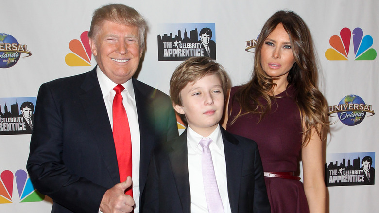 Donald, Barron and Melania Trump pose at an event together