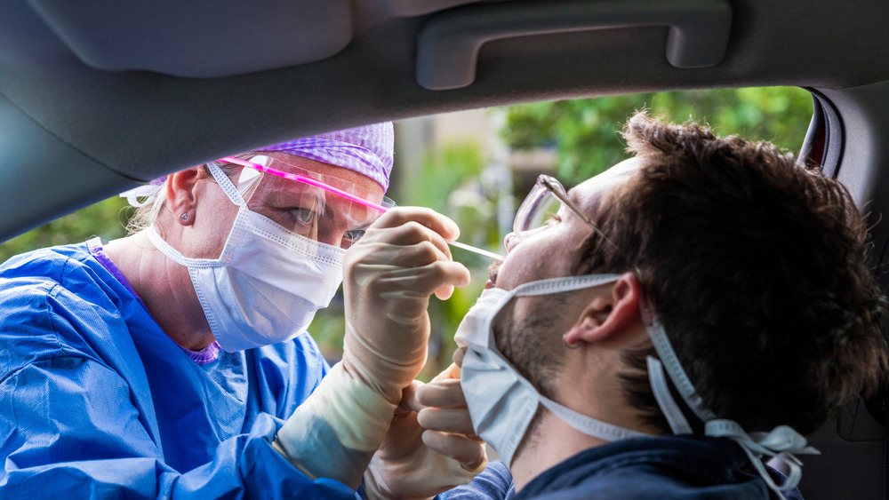 Doctor testing patient in car for coronavirus