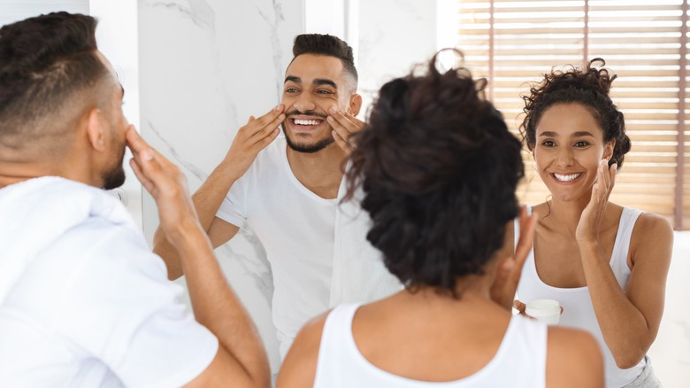 A couple applying face cream