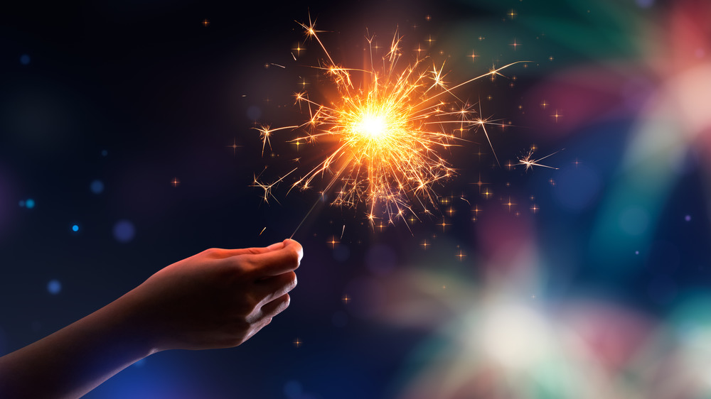 child holding sparkler on July 4th