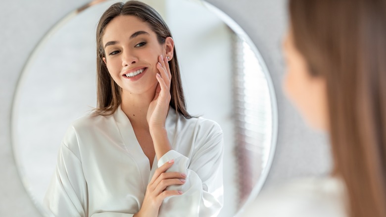 Woman looking at herself in mirror