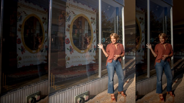 Erin Napier posing in front a sign for her book "Heirloom Rooms"