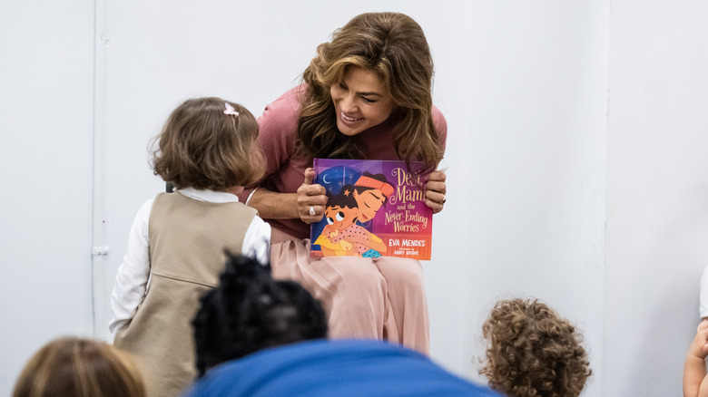 Eva Mendes reading her book in 2024