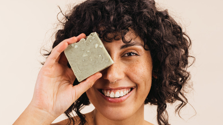 Woman posing with a bar of soap 