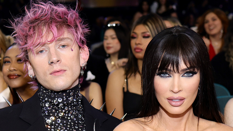 Machine Gun Kelly and Megan Fox sit at the Billboard Awards