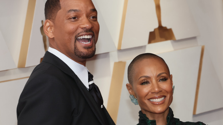 Will Smith and Jada Pinkett-Smith smiling at the 2022 Oscars