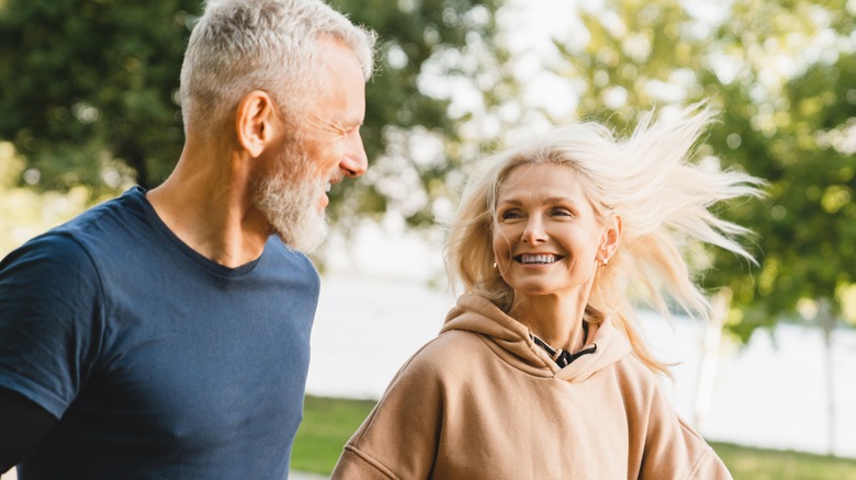 Two older people jogging