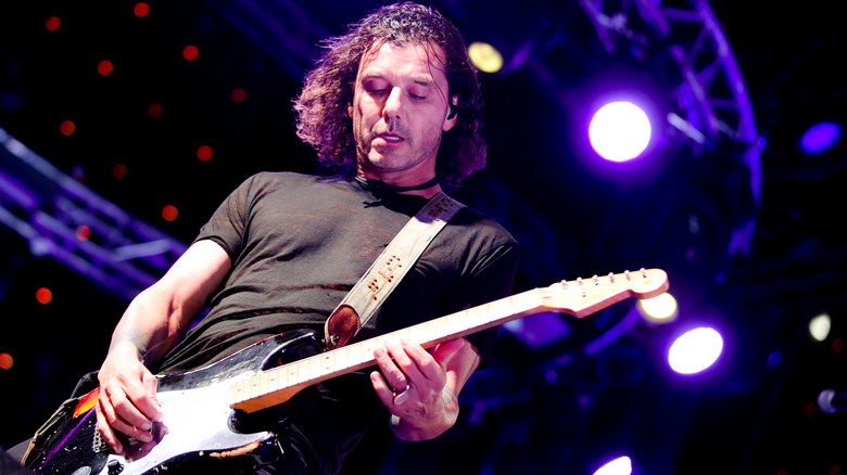 Gavin Rossdale playing guitar on stage