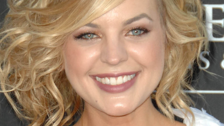 Kirsten Storms with curled hair and wide smile