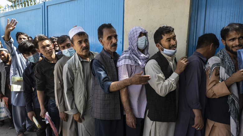 Line of Afghanis waiting for passports