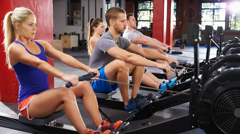 People rowing indoors in fitness studio