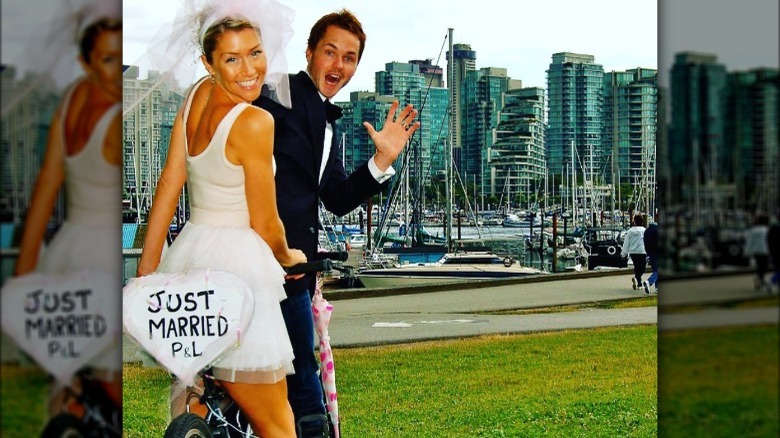 Paul Campbell and Lorie Metz posing with Just Married sign