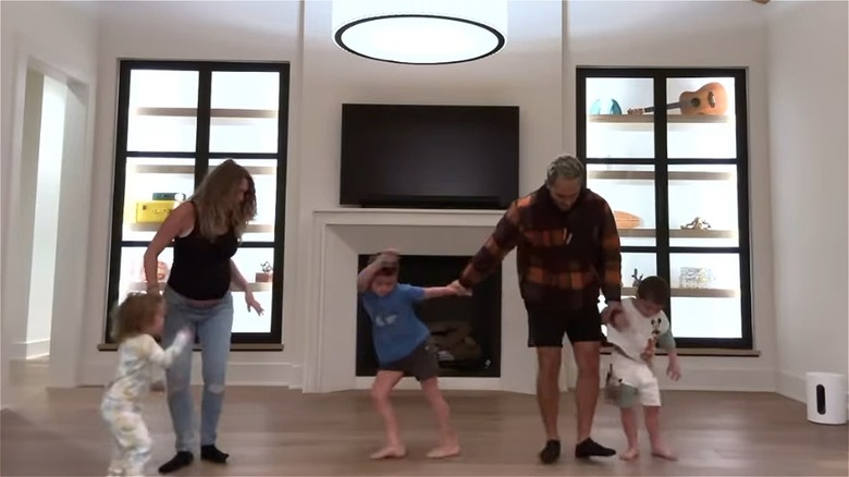 Alexa and Carlos PenaVega dance in living room with children