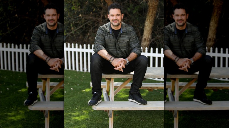 Ryan Paevey on a bench