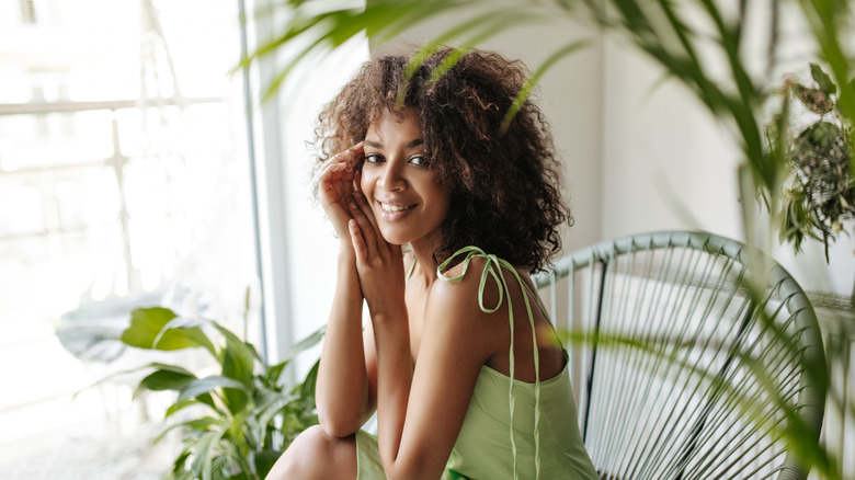 woman smiling near plants