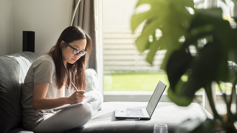 woman working on couch