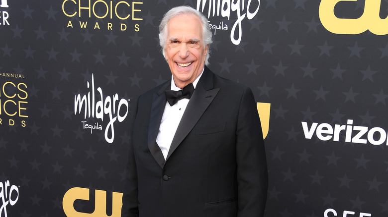 Henry Winkler smiling in a suit