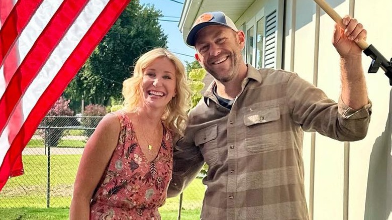 Jenny and Dave Marrs smiling with U.S. flag