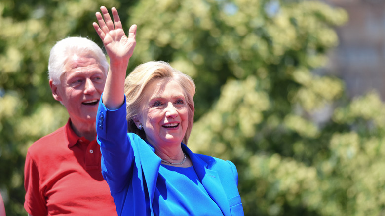 Hillary Clinton waving with Bill Clinton