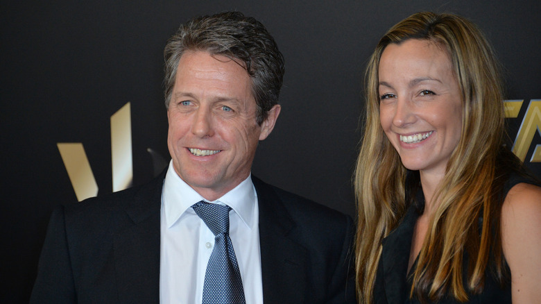 Hugh Grant smiling with his wife Anna Eberstein