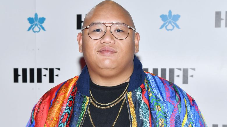 Jacob Batalon on the red carpet with colorful jacket and glasses