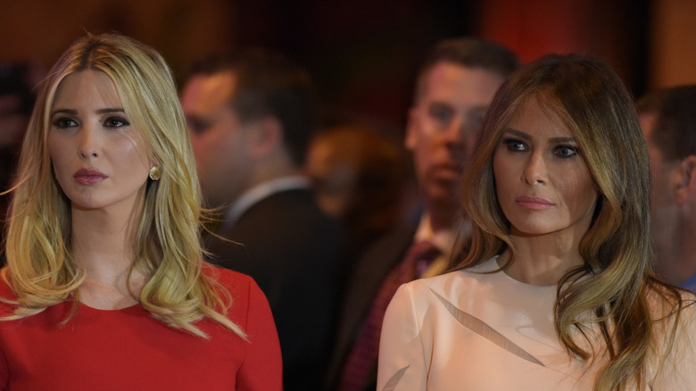 Ivanka and Melania Trump staring ahead while standing next to one another.