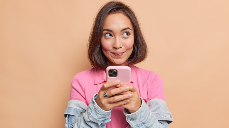 Woman smiling and holding phone