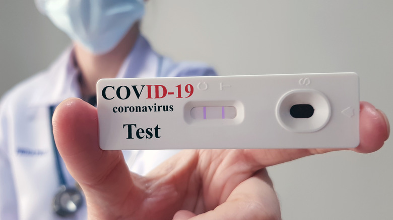 Physician holding a COVID-19 test