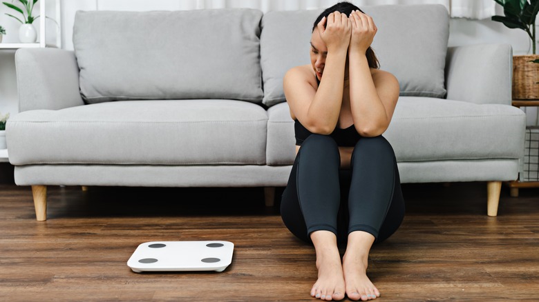 woman looking at scale