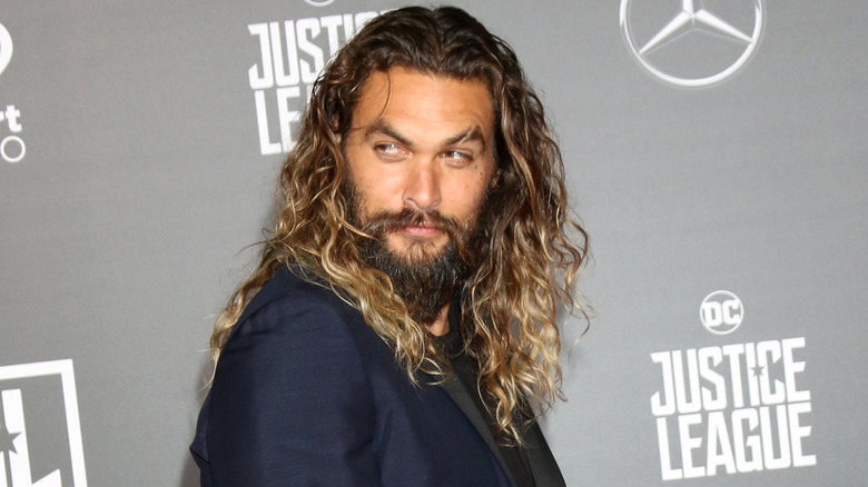 Jason Momoa looking ove his shoulder