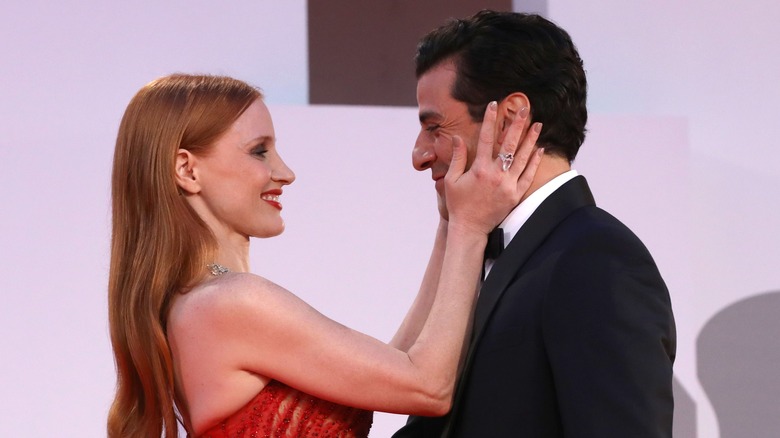 Jessica Chastain touching Oscar Isaac's face