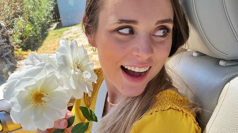 Jinger Duggar posing with flower