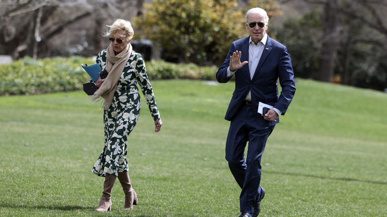 Joe and Jill Biden walking by White House