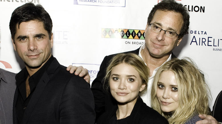 John Stamos, Bob Saget, and Mary Kate and Ashley Olsen smiling