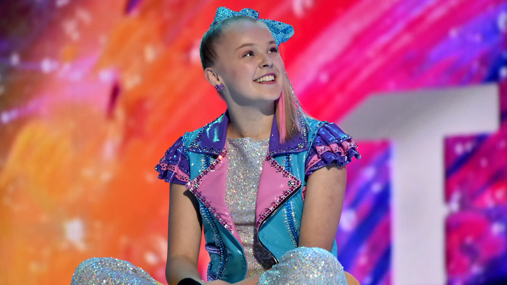 JoJo Siwa sitting onstage