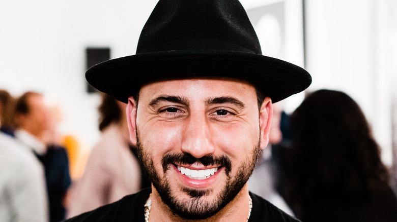 Josh Altman smiling in a hat