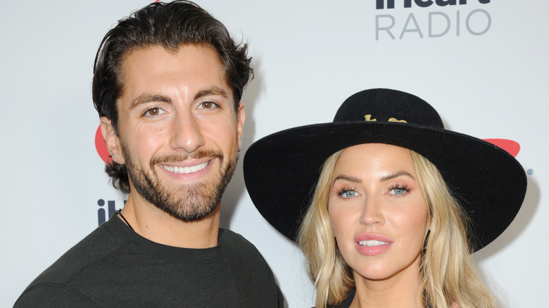 Kaitlyn Bristowe and Jason Tartick pose for a photo. 