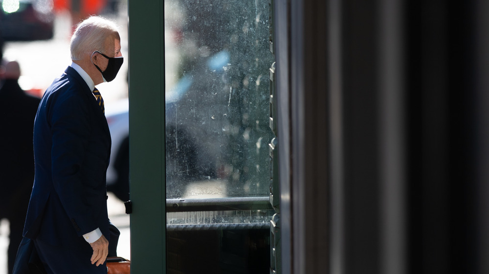 Masked Joe Biden entering building