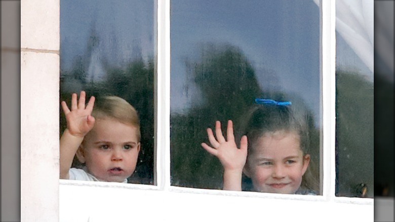 Prince Louis and Princess Charlotte at window 