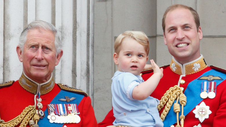 Prince Charles, Prince George, and Prince William on the balcony 