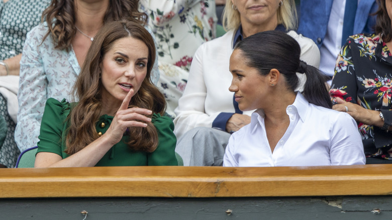 Kate Middleton talking to Meghan Markle