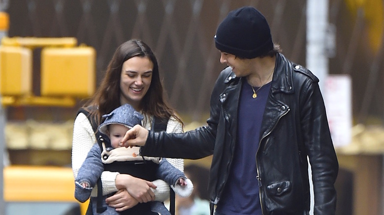 Keira Knightley and James Righton walk and hold baby Edie