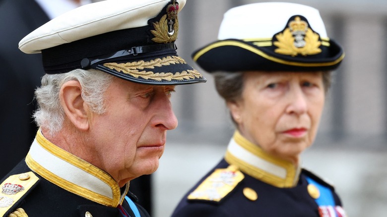 Princess Anne looking at King Charles III