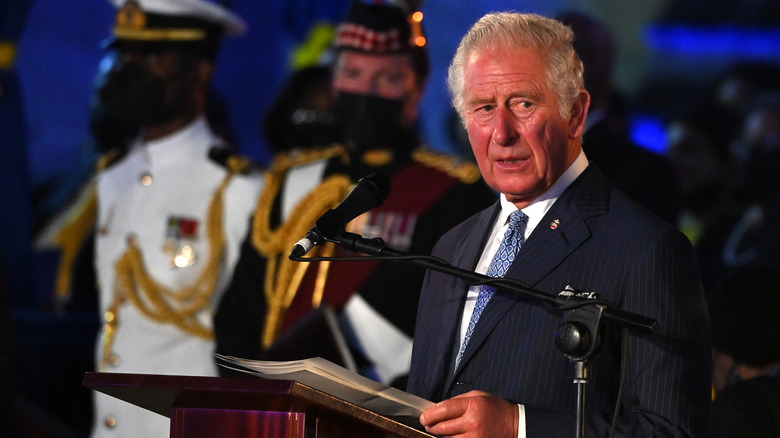 King Charles looking serious giving speech in Barbados