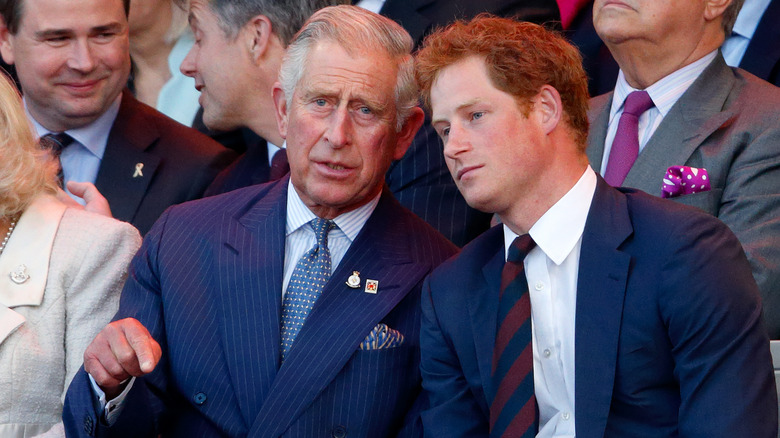 King Charles and Prince Harry talking at an event