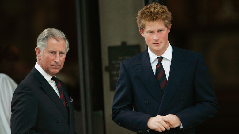 Prince Harry and King Charles III looking at the camera in suits