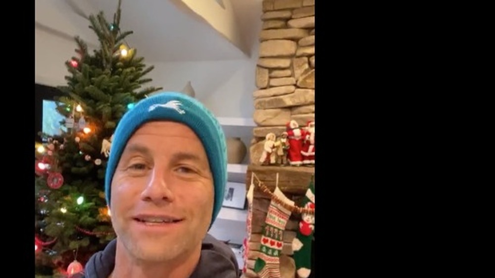 Kirk Cameron posing in front of Christmas tree