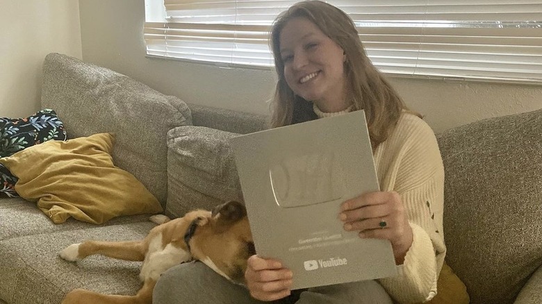 Gwendlyn Brown posing with a YouTube plaque