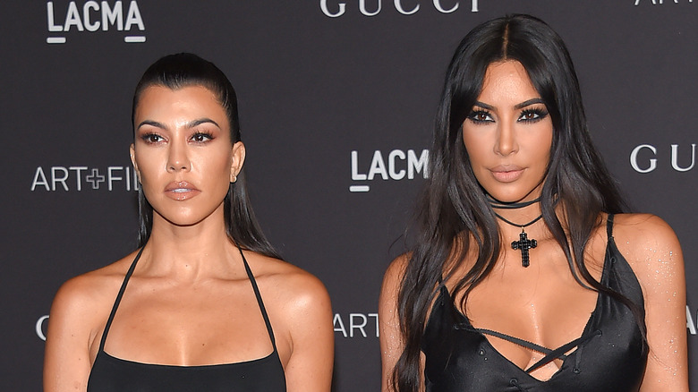 Kourtney Kardashian and Kim Kardashian on the red carpet